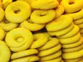 Una pila di dolcetti veneziani gialli, a forma di ciambella, con una texture leggermente ruvida.