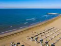 Spiaggia di Cavallino-Treporti con ombrelloni e lettini pronti per l'estate. Scopri come arrivare in questo paradiso!