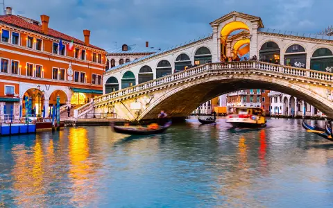 Il Ponte di Rialto, uno dei tanti ponti di Venezia, attraversa il Canal Grande con gondole e vaporetti.