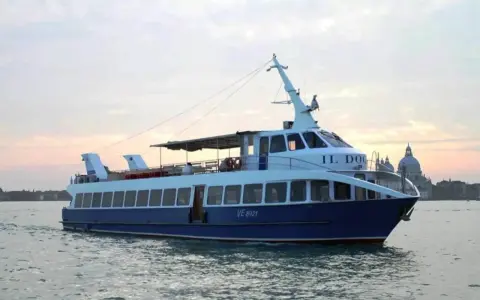 Battello "Il Doge" in navigazione, da Punta Sabbioni verso Venezia, con la Basilica di Santa Maria della Salute sullo sfondo.