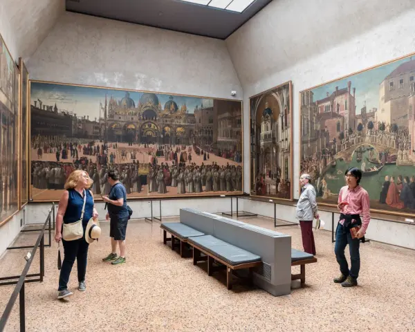 Visitanti ammirano grandi dipinti storici in uno dei musei d'arte a Venezia.
