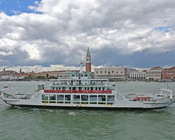 Traghetto ACTV che naviga sul Canal Grande, con lo sfondo di Venezia e il Palazzo Ducale.