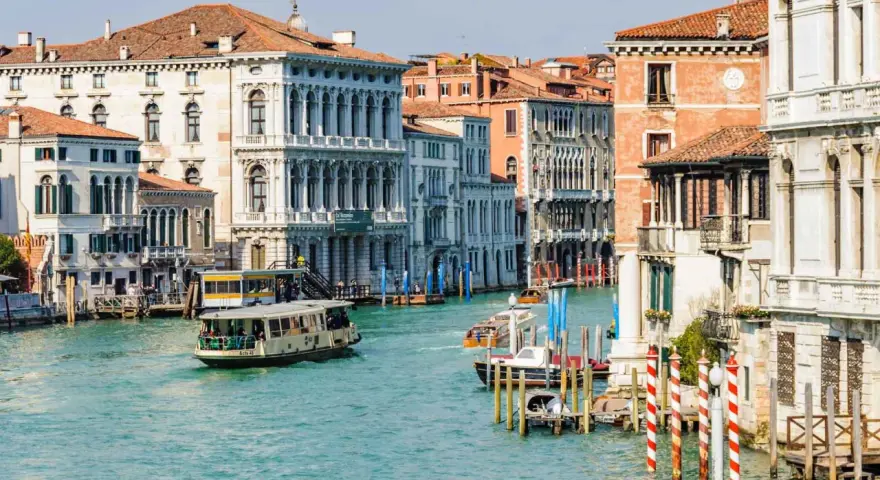 Vaporetti sul Canal Grande, un modo efficiente per il pagamento dei trasporti a Venezia. Palazzi storici e acqua turchese.