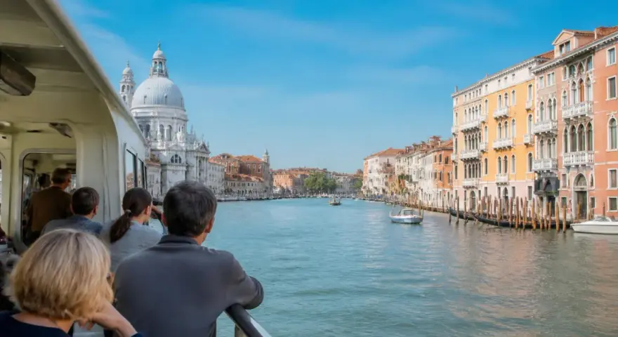 Gente sul vaporetto ammira il Canal Grande, con palazzi colorati e la Basilica di Santa Maria della Salute. Un viaggio tra Murano e Burano.